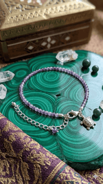 Amethyst Anklet by AstroGuruji Kept On A Green Wooden Display